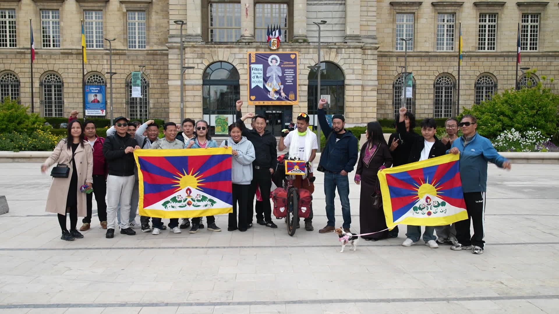 Fists raised, flags held high — Tibetan activist Sonam Dhundup is welcomed by his community in Rouen, France. One bicycle, one mission, one message: Free Tibet.